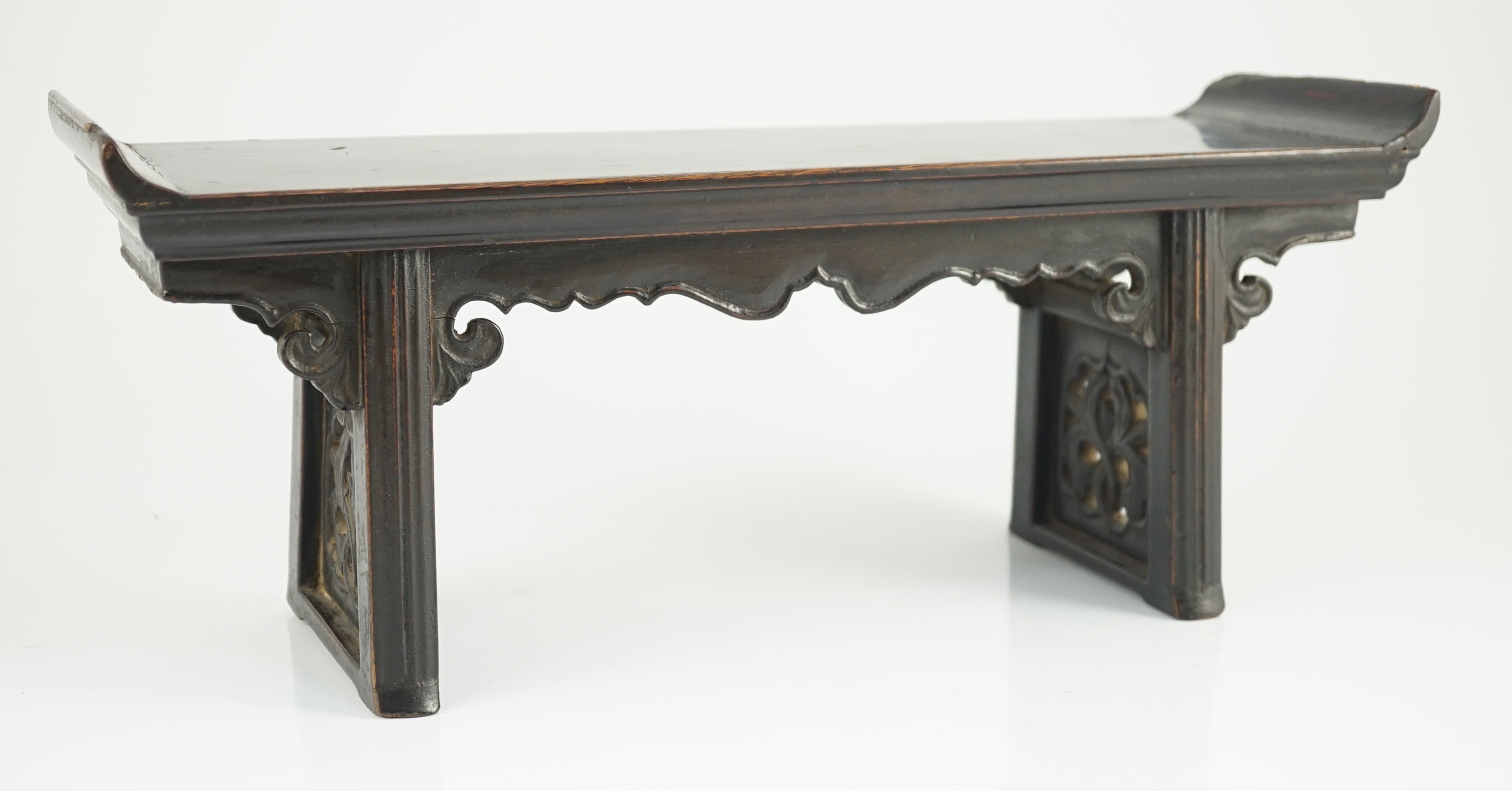 A Chinese late Ming lacquered wood model of an altar table, 17th century, 41cm wide, 16.5cm high, minor losses